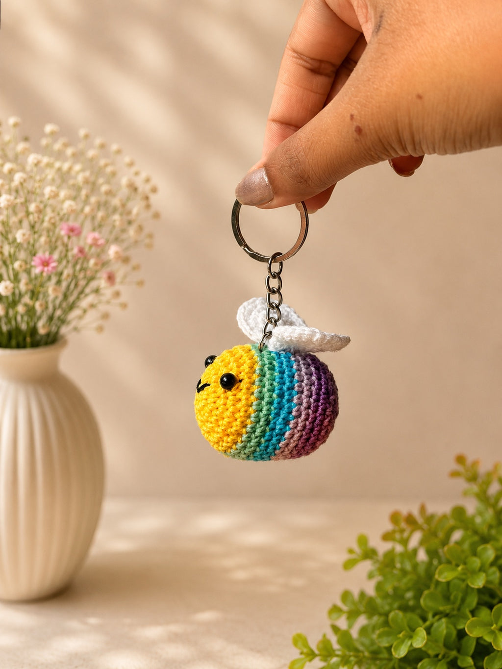 Handmade crochet rainbow bee keychain by Rubber Band