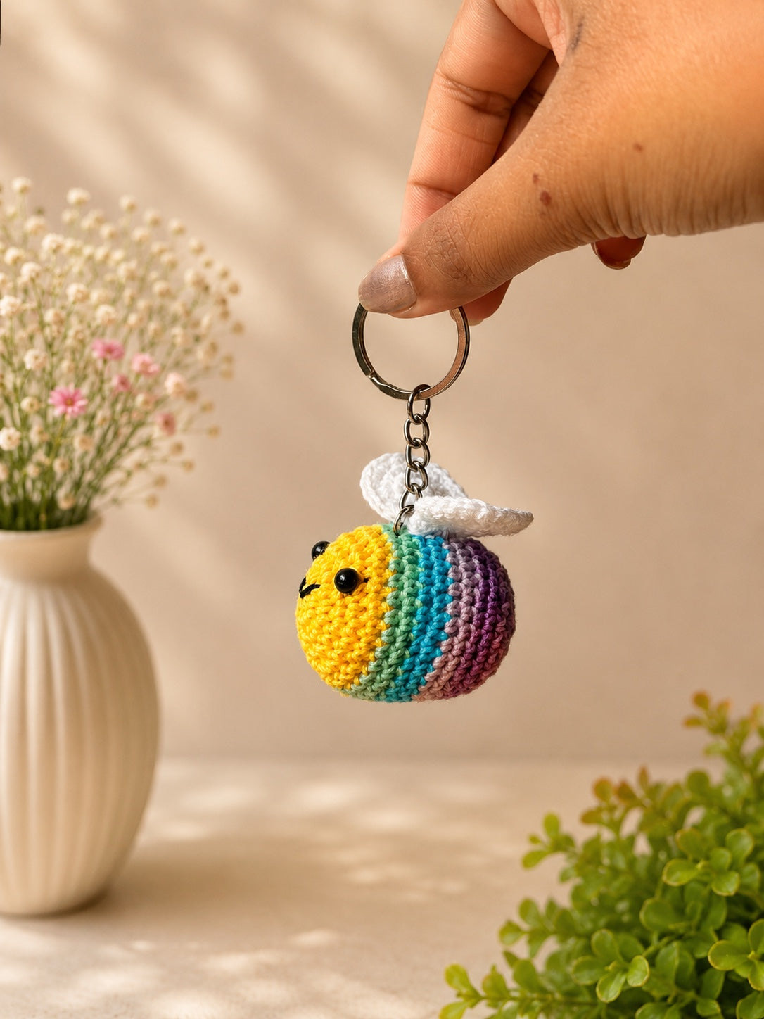 Handmade crochet rainbow bee keychain by Rubber Band