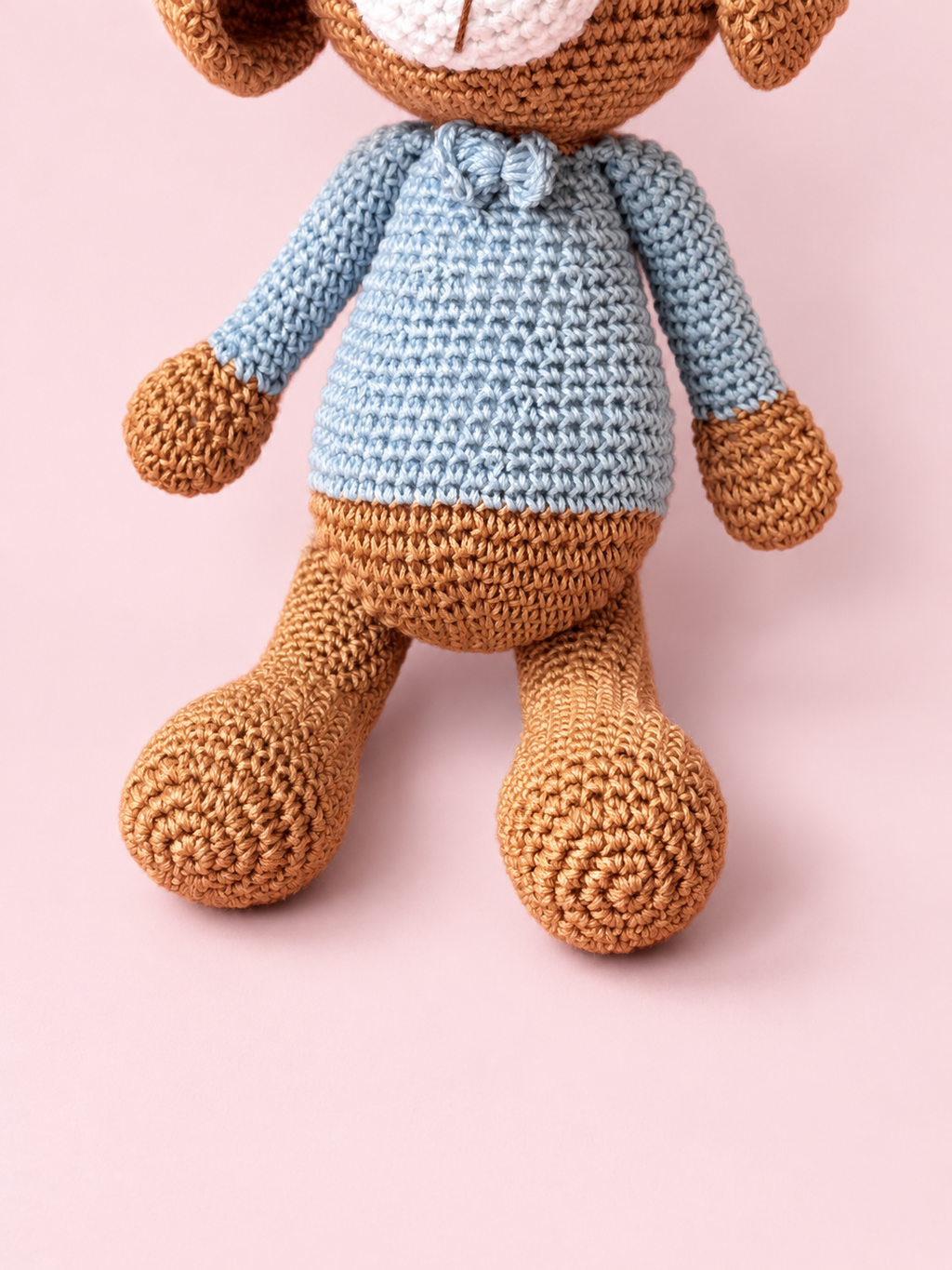 Detail of Biscuit the Puppy's pale blue sweater and long legs