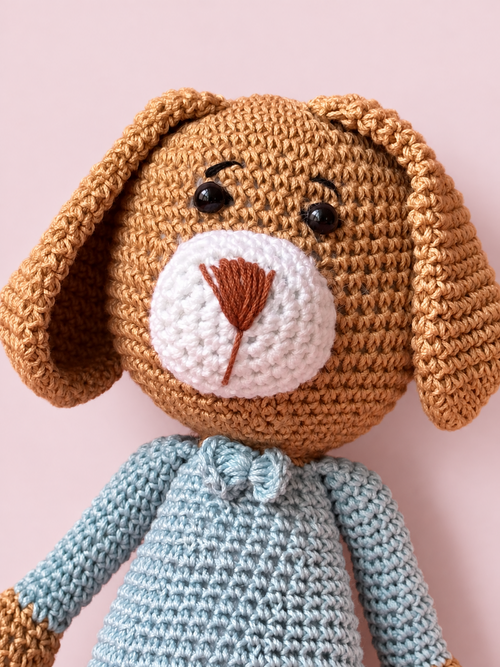 Close-up of Biscuit the Puppy's crocheted face