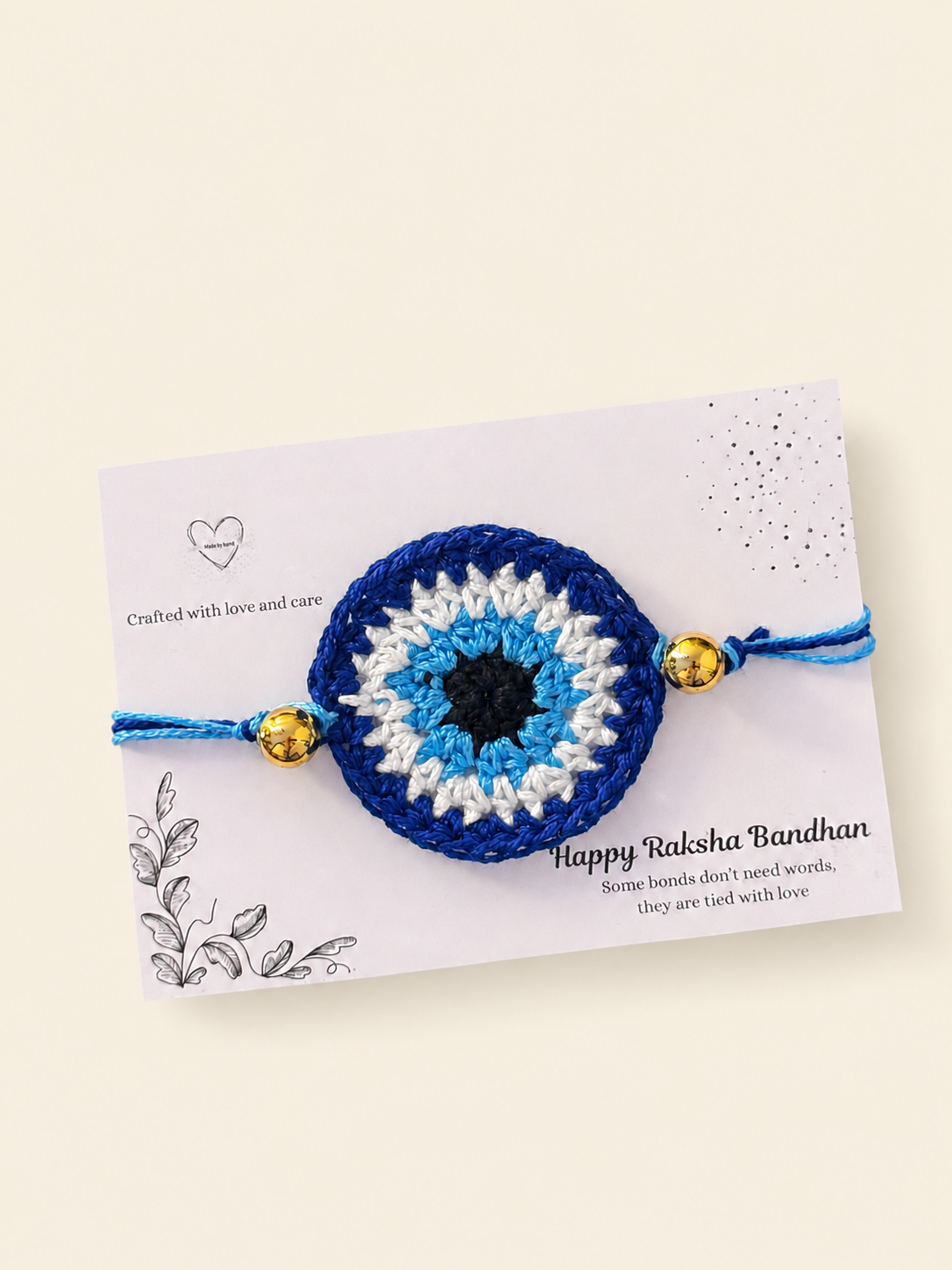 Blue crochet nazar rakhi presented on a Raksha Bandhan card