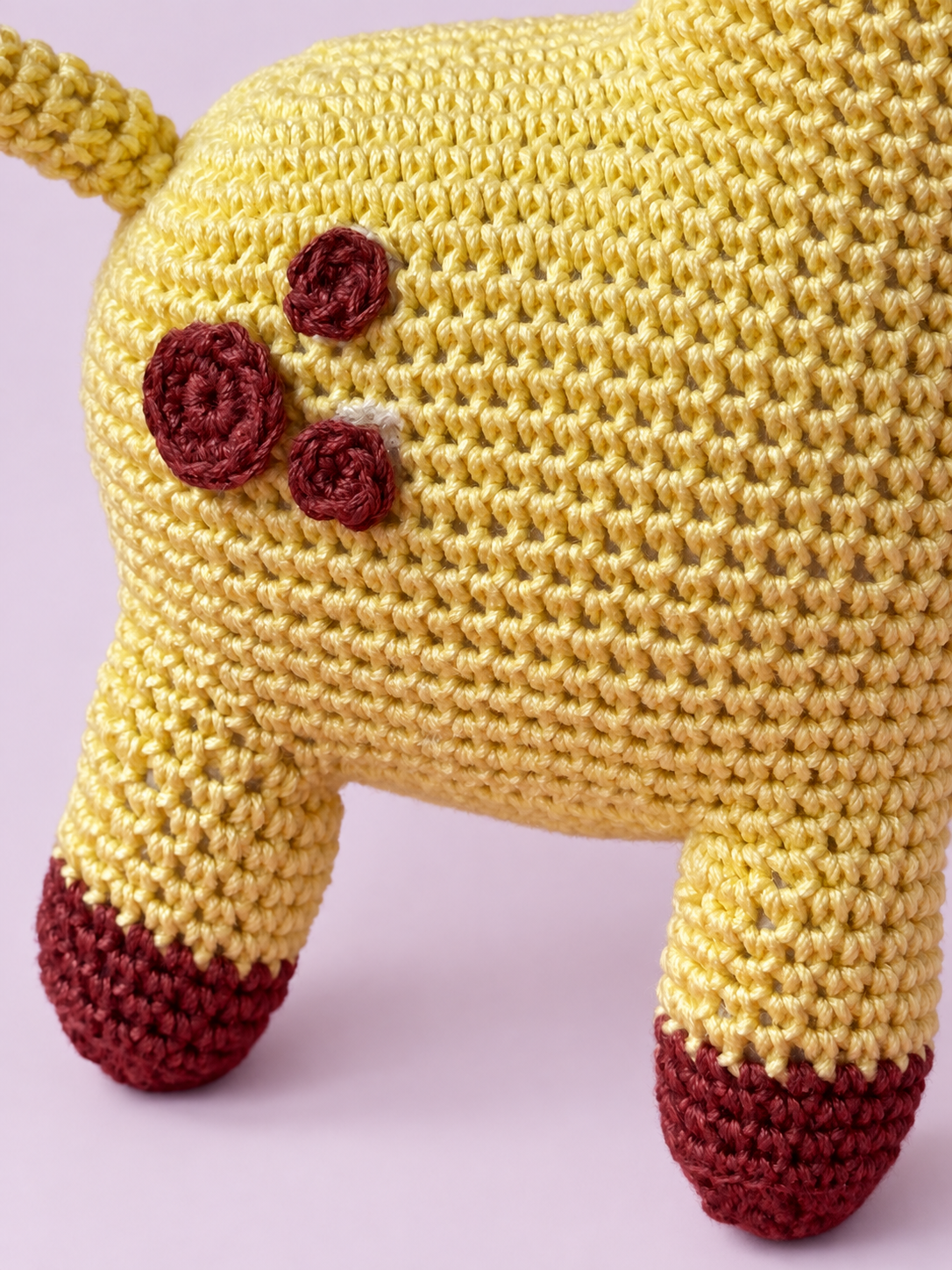 Close-up of Dottie the Giraffe's crochet spots and hooves