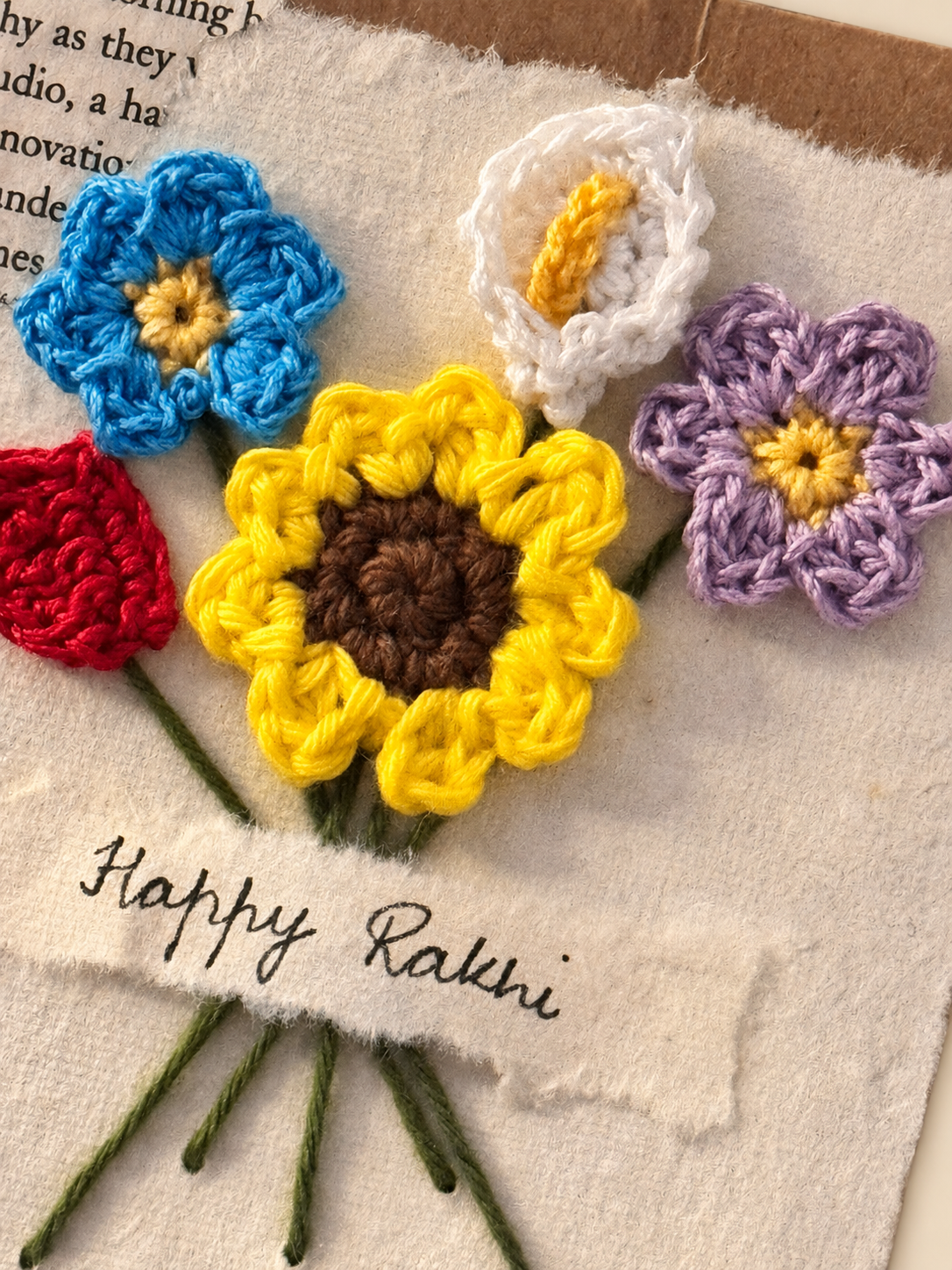 Handmade Happy Rakhi greeting card decorated with crochet flowers