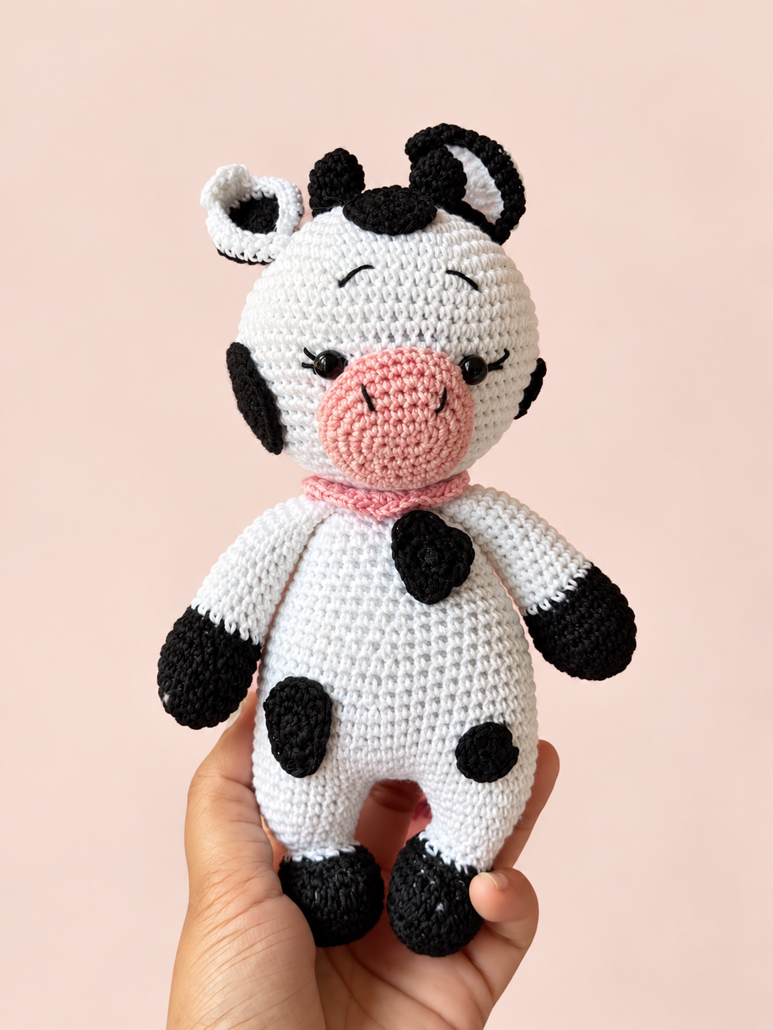 Molly the Cow shown in hand for scale