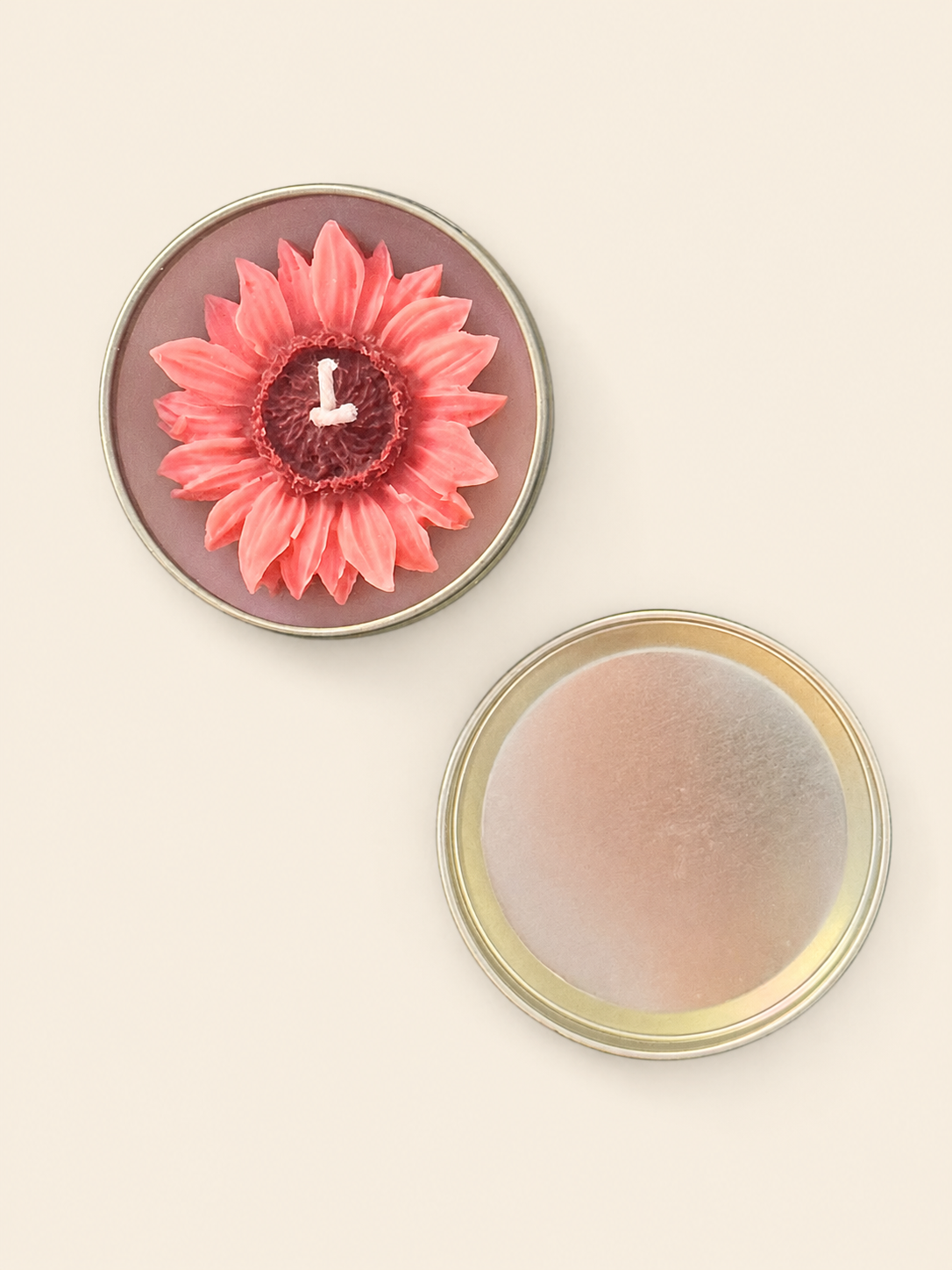 Pink flower-shaped candle in a reusable metal tin with lid