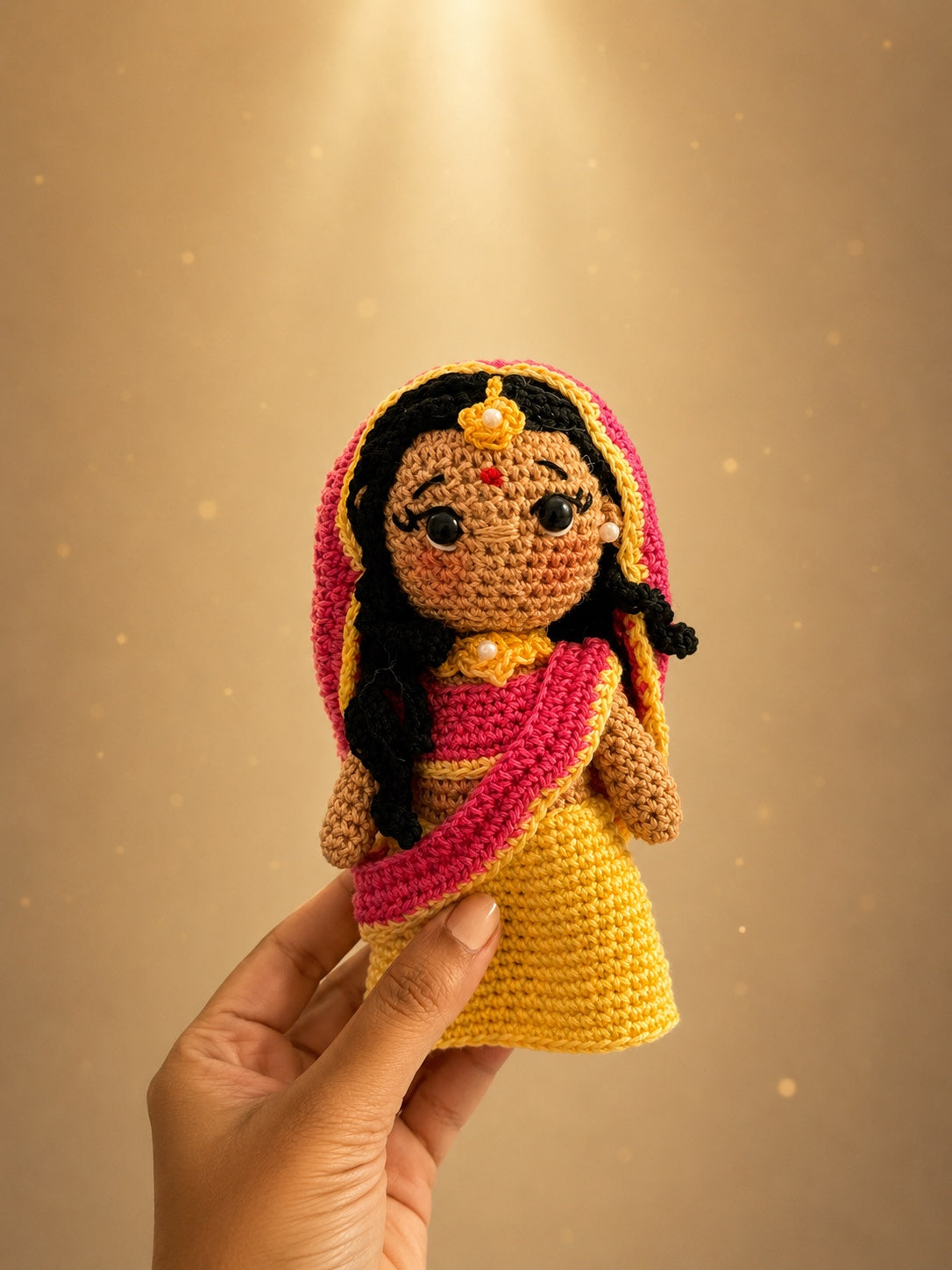 Handmade crochet Radha doll on a golden soft background