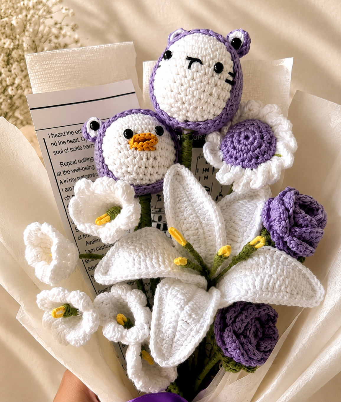 Close-up of handmade crochet white and purple bouquet by Rubber Band