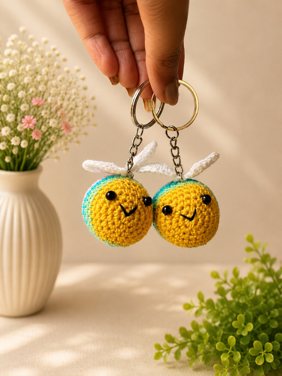 Pair of handmade crochet rainbow bee keychains by Rubber Band