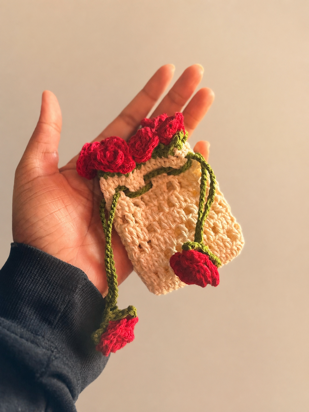 Close-up of handmade crochet rose bouquet bag charm