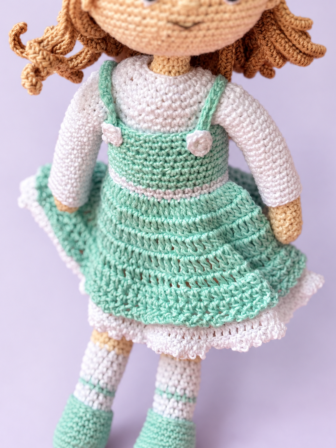 Close-up of Rosie's mint crochet dress