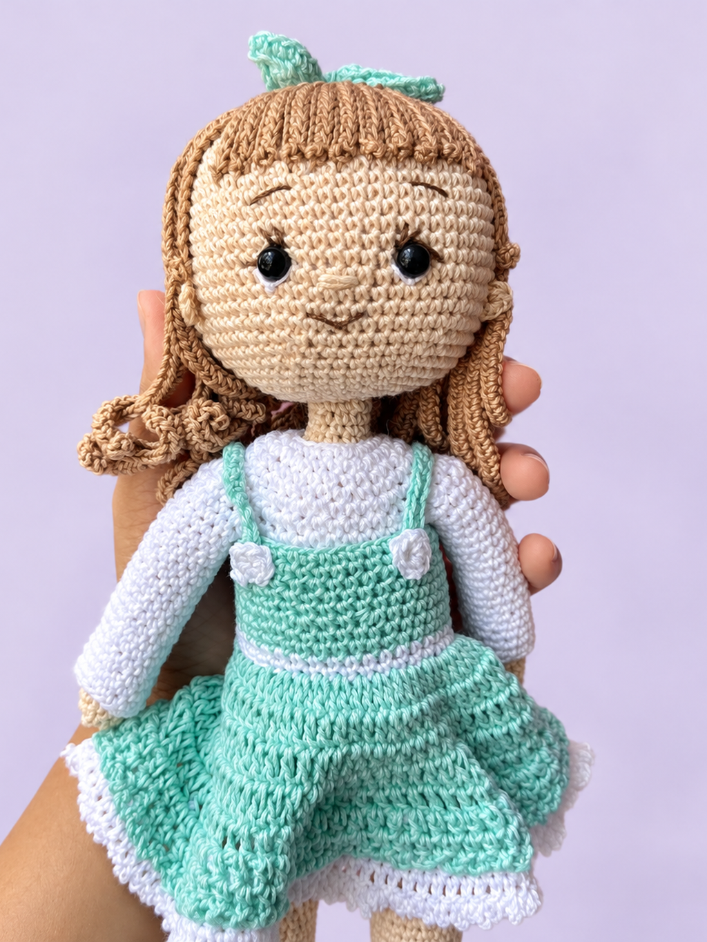 Rosie the Doll in mint dress held in hand for scale