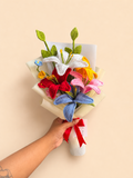 Handmade colorful crochet lily bouquet held in hand with gift-ready wrapping