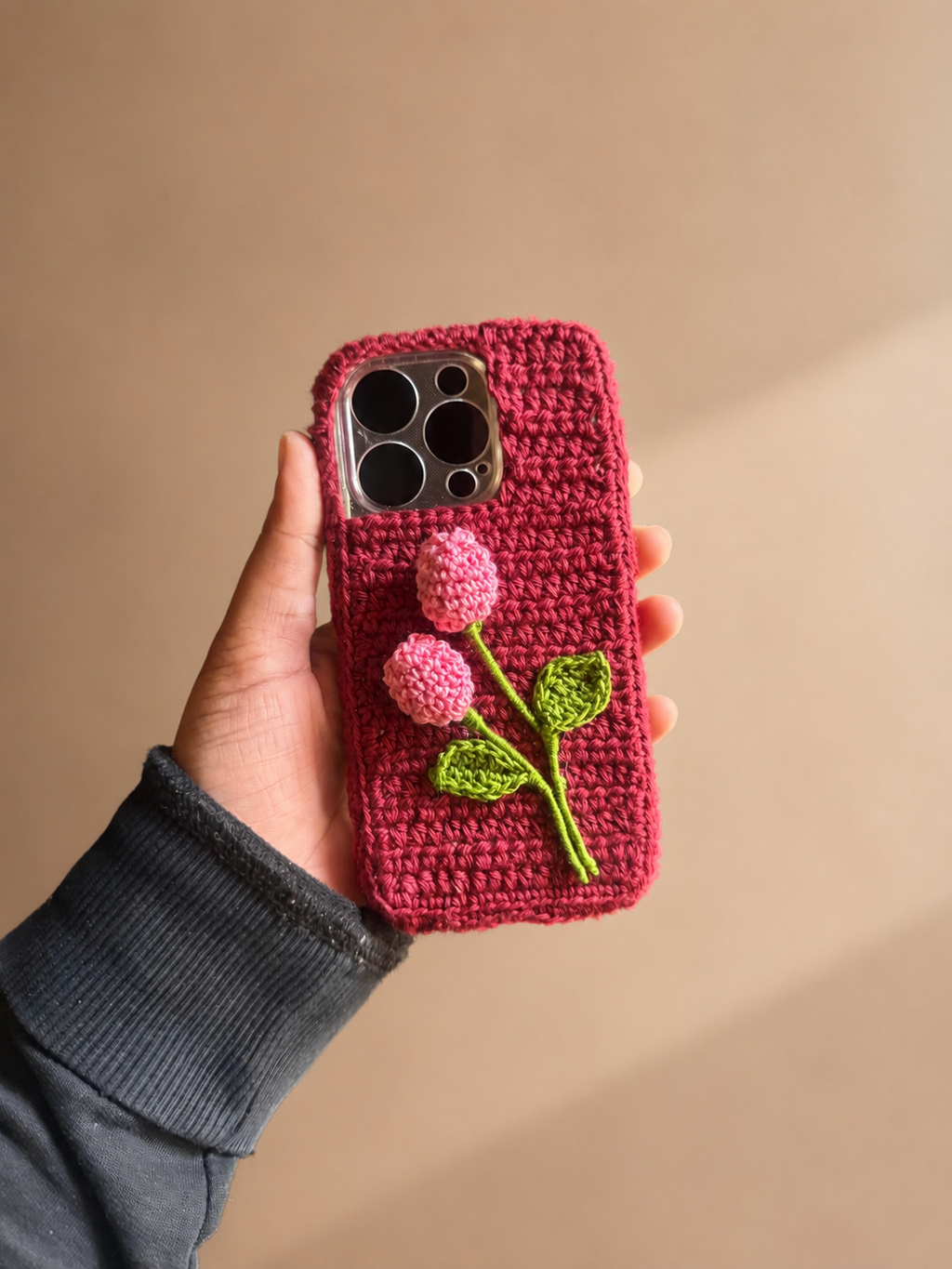 Handmade deep pink crochet phone cover with two pink flower buds