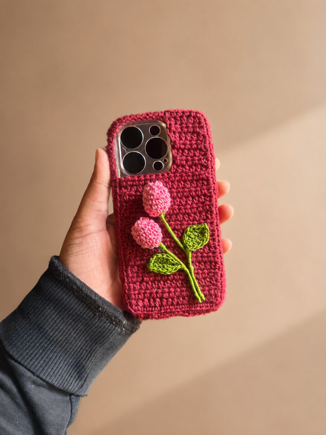 Handmade deep pink crochet phone cover with two pink flower buds