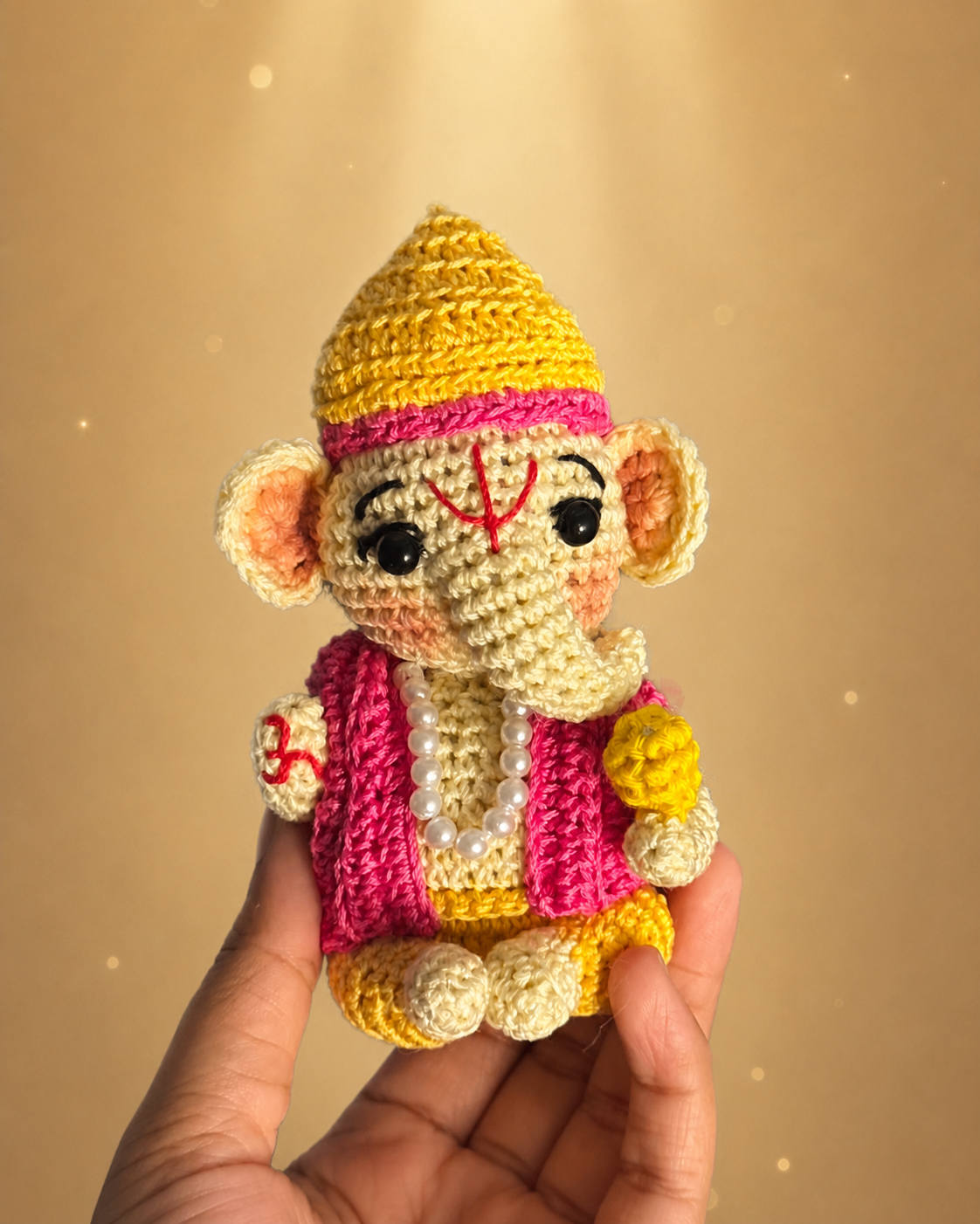 Handmade crochet Ganesh Ji doll front view held in hand