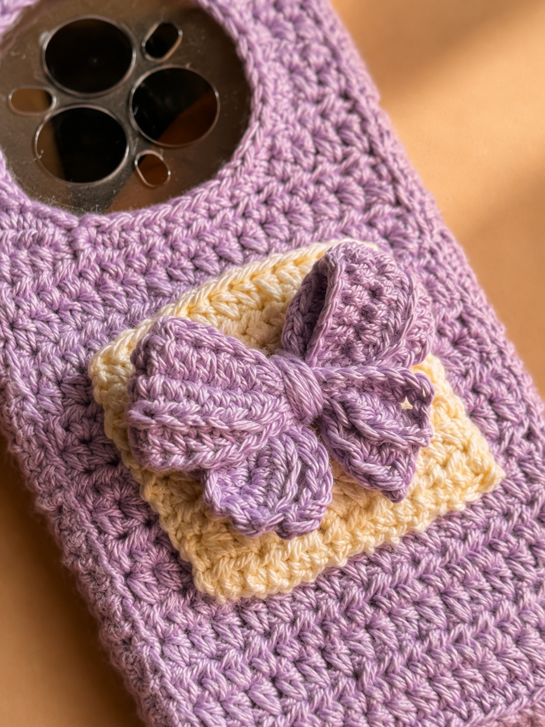 Close-up of raised lavender crochet bow on a cream pocket