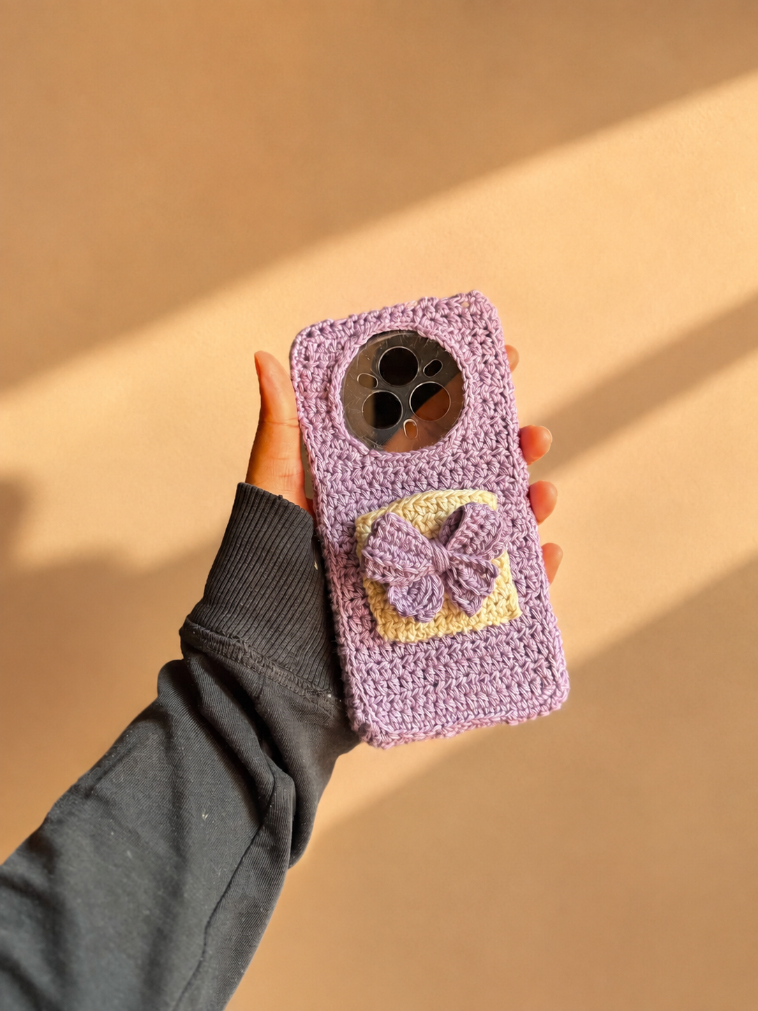 Handmade lavender crochet phone cover with cream pocket and raised bow