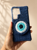 Handmade navy crochet phone cover with raised blue evil eye design
