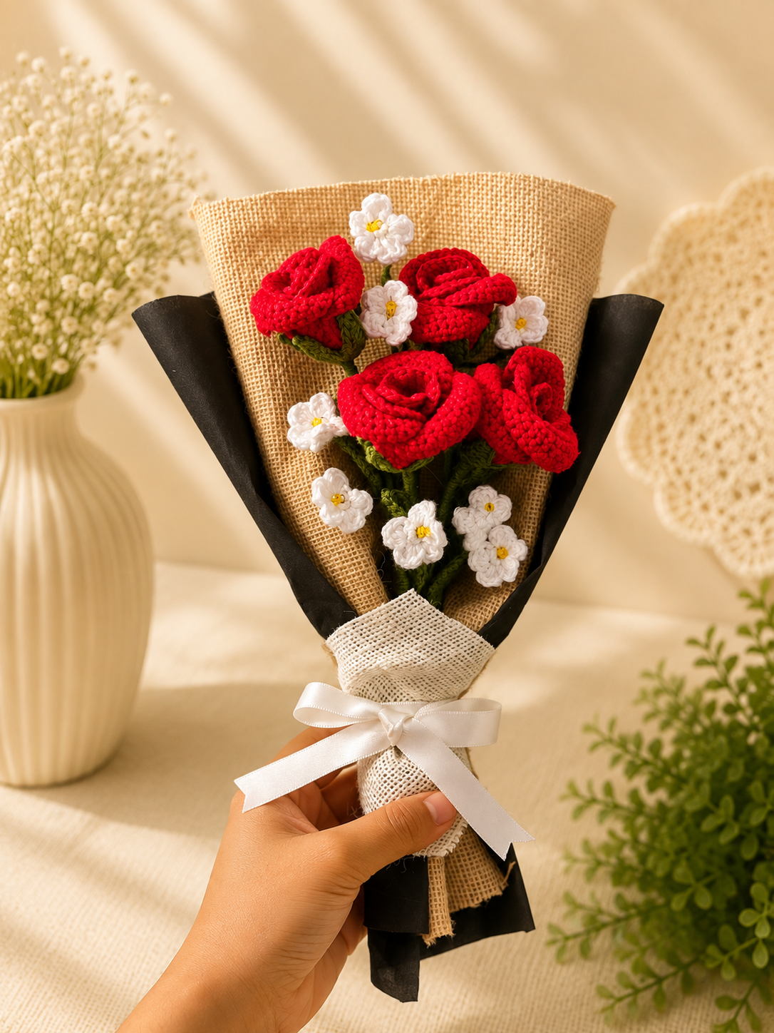 Handmade crochet red rose bouquet with white blossoms in burlap and black wrapping