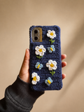 Handmade navy crochet phone cover decorated with white flowers and blue butterflies