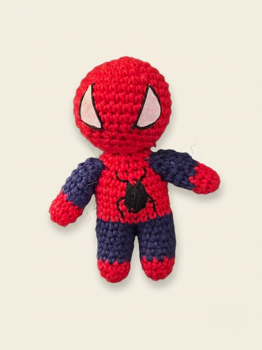 Handmade red and blue Spider-Man-inspired crochet doll