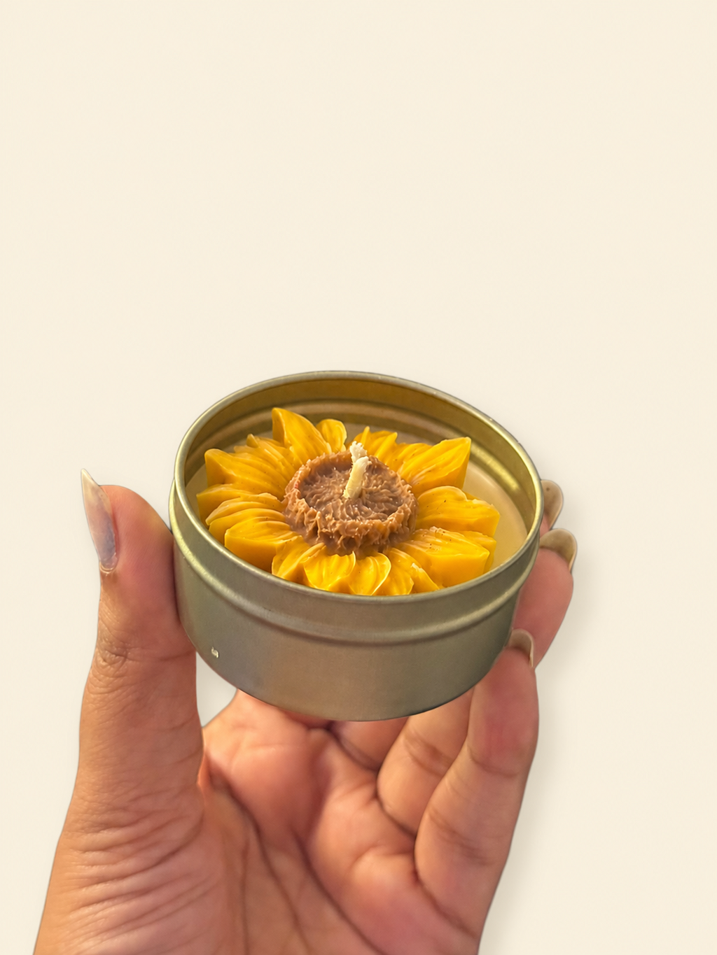 Sunflower-shaped candle in a reusable metal tin included in the Rakhi gift set