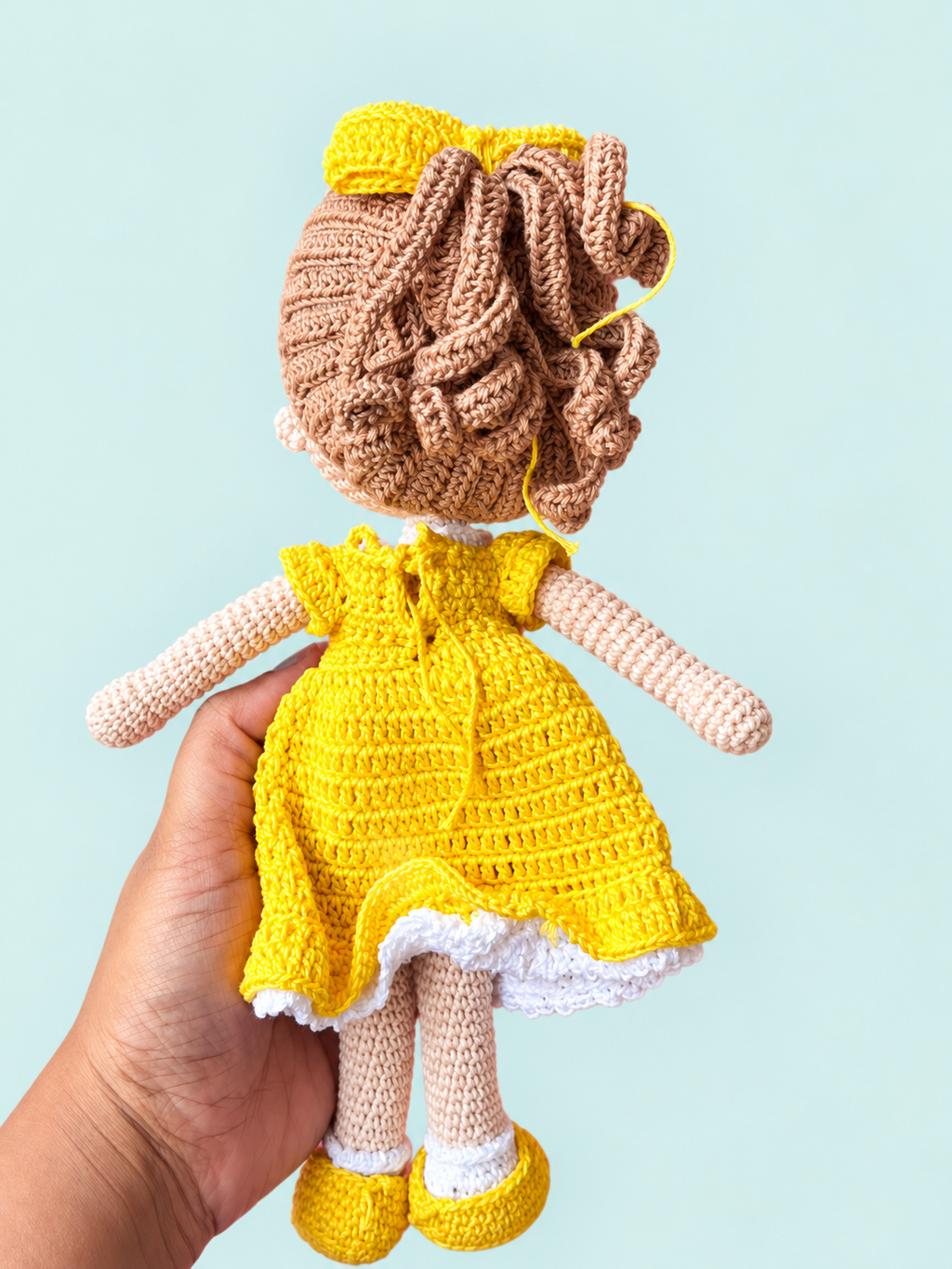 Sunny the Doll in yellow dress, back view